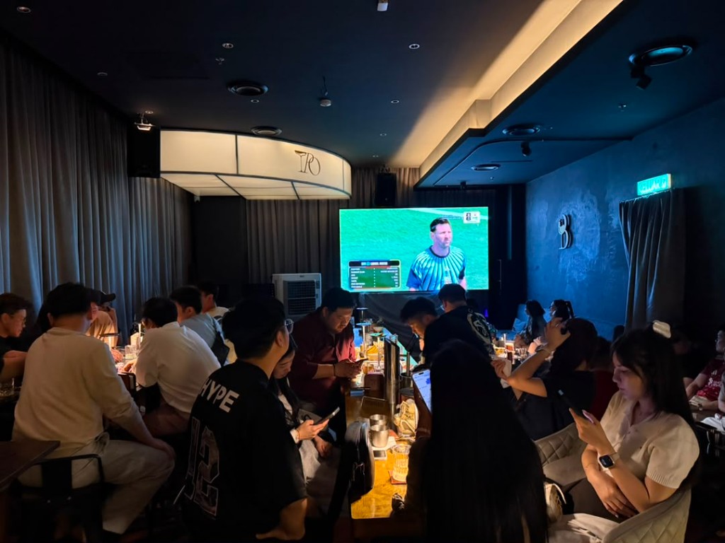 Guests gathered at Tipsy Plus One for a private event with big-screen viewing