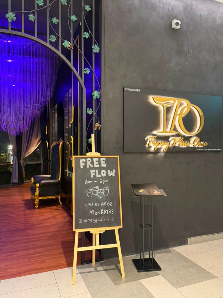Tipsy Plus One entrance with illuminated signage