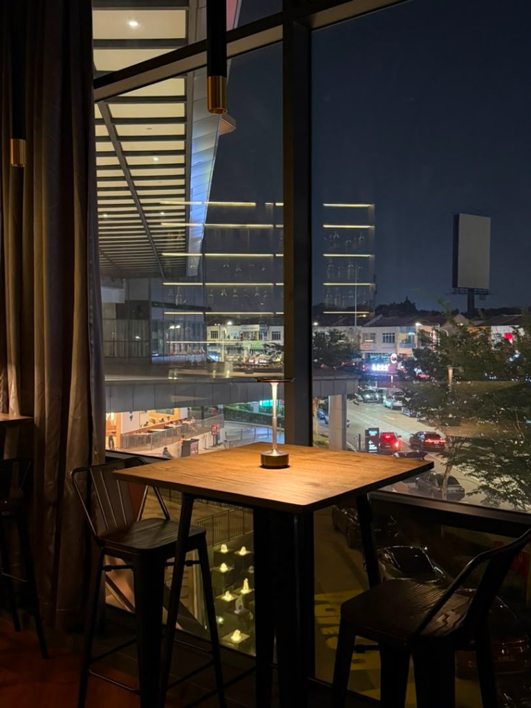 Window seating overlooking the city at night